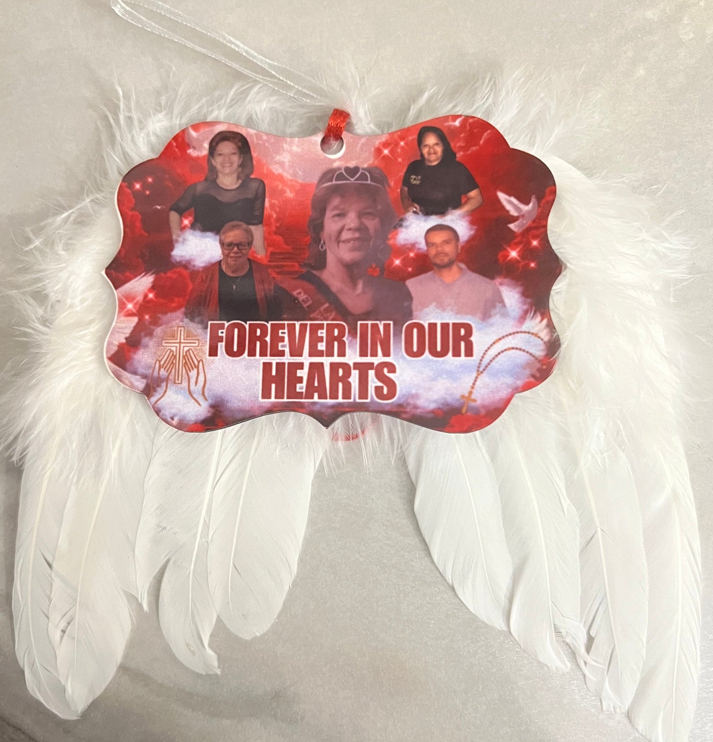 Memorial with angel wings and a red plaque with text on a white background
